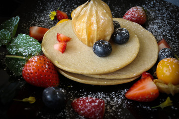Organic pancake topping with honey, berry and fruit healthy food.
