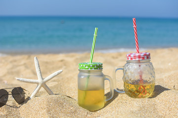 Cold refreshment on sandy beach.  Summer holidays background, concept of vacations