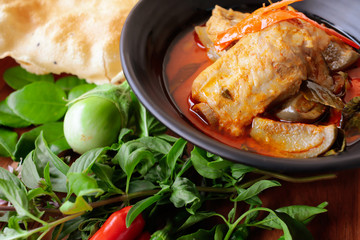 Thai food spicy pork spare rib red curry with crispy rice cake, homemade organic vegetable and herbs asian culinary.