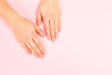 female  manicure. Beautiful young woman's hands on pastel pink  background - Image