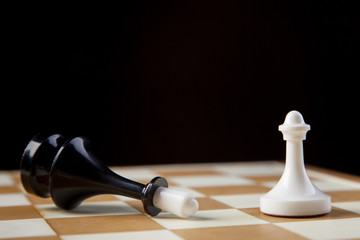 chess pieces on chessboard, checkmate photo dark bg