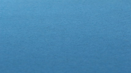 blue paper background with pronounced cardboard texture