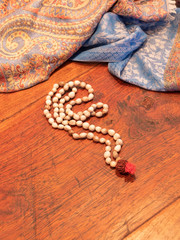 a pebble colored Indian necklace on a wooden table