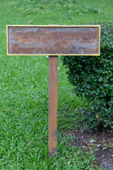 Old wooden sign in the outdoor park.