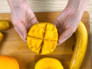 Fresh ripe mango in woman hands