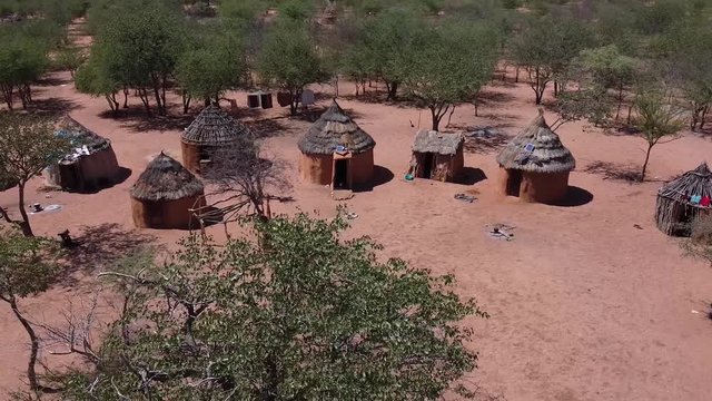The village of a native tribe Himba in the forests of Namibia, aerial shot
