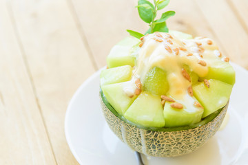 Melon Bingsu with Sweetened Condensed Milk on wood table 