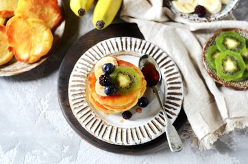Fritters with honey, banana, blueberries and kiwi, breakfast
