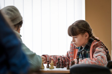 A teenage girl plays a chess game with an experienced woman. Game of chess. Chess tournament