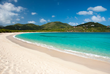 Fototapeta na wymiar Bright scenic empty view of wide curving Caribbean beach at Long Bay, Beef Island, Tortola, British Virgin Islands