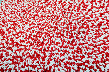  A lot of red and white capsule pills pattern, macro