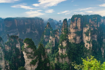 Gigantic pillar mountains rising from the canyon. Yellow Stone Stronghold (Huangshi Zhai), Zhangjiajie Natural Park, Hunan province, China. 