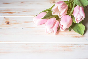A beautiful bouquet of pink tulips on a light background.