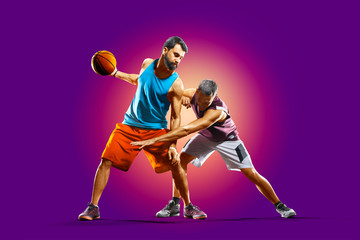 Fototapeta na wymiar colourful professional basketball players isolated over purple background