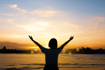 Fototapeta premium Woman rise hands up to sky freedom concept with blue sky.