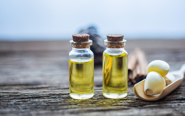  top view of rosemary essential oil on a rustic wooden background. Herbal oil concept