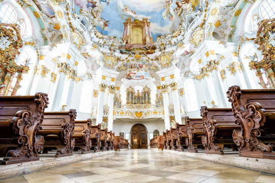 WIESKIRCHE, GERMANY – MARCH 07: View on rococo interior of chapel with benches on March 07, 2016 in Wieskirche, Germany.