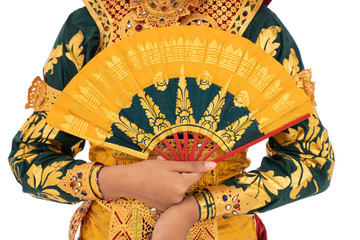Cropped of hand hold a fan portrait of Balinese dancer wear traditional clothing with Hindu cultural accessory symbols