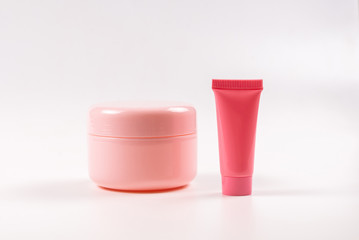 Pink plastic bottles for hygiene products, cosmetics, hygiene products on a white background. Copy...