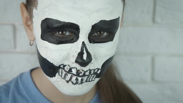 Skull pattern on the face. Halloween.