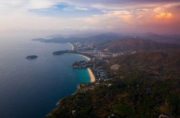 Fototapeta na wymiar Aerial view of the coastline of Phuket island with tropical sandy beaches and mountains at sunset, Thailand