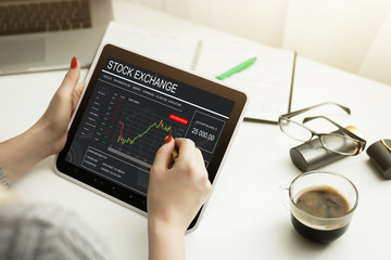 Conceptual hand writing on a laptop with graphs of the financial crisis