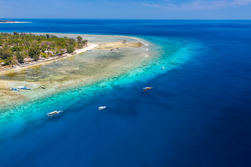 Fototapeta na wymiar Aerial drone view of snorkelers and boats above a coral reef in a clear, tropical ocean