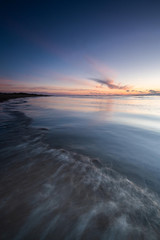 Obraz premium Tranquil colorful sunset over sea, viewed from the dutch coast. The Netherlands