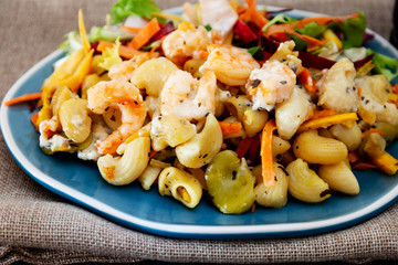 Cooked pasta with peeled shrimp, coconut milk sauce and broccoli