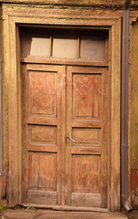 Fototapeta na wymiar Closed vintage wooden door in old building