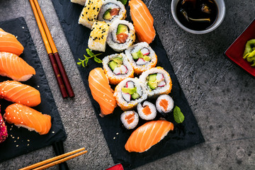 apanese sushi food. Maki ands rolls with tuna, salmon, shrimp, crab and avocado. Top view of...