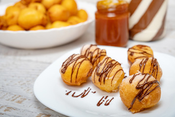 Small dessert donuts with chocolate frosting and jam