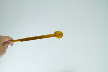 Hand holding a tuning fork and crystal stone  .