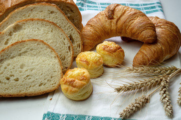 delicious bakery with white flour on a cloth with grain on white table