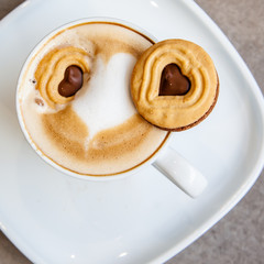 Hot coffee art latte and cookies