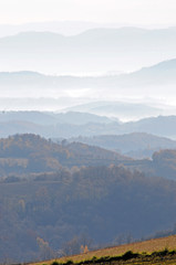 Naklejka premium Distant hills in the haze. Beautiful mountain scenery. Mystical rural scenes. Scattered houses of mountain villages. Beautiful nature background.