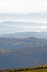  Distant hills in the haze. Beautiful mountain scenery. Mystical rural scenes. Scattered houses of mountain villages. Beautiful nature background.
