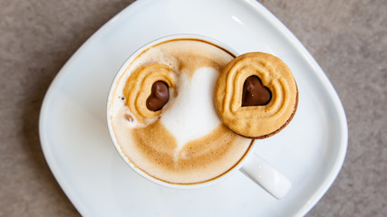 Hot coffee art latte and cookies