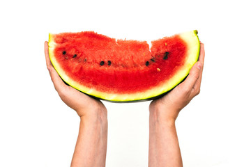 Slice of watermelon in female hands isolated on a white background. Juicy watermelon with red pulp. Healthy eating and summer concept.