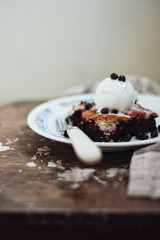Homemade blueberry pie with vanilla ice-cream on wooden background - 329300465