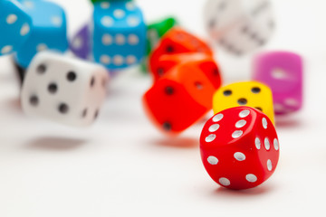 Playing dice at white wooden background.