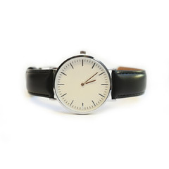 wristwatch with a black strap and a white dial on an isolated white background.