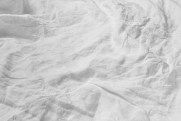 Crumpled fabric white textile background.