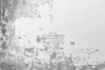 Close-up of a weathered, old and moldy concrete wall, plastering painted in white is broken and peeled off. High resolution abstract full frame textured background in black and white.