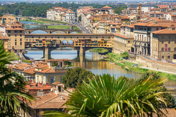 Fototapeta na wymiar Beautiful wide angle view of the Florence bridges over Arno river in hot summer day. Travel destination Tuscany, Italy