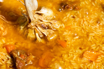 Step by step Cooking tasty pilaf. Rice added to Zirvak in a cauldron. Traditional pilaf cooking