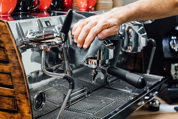 Barista cleaning the coffee maker