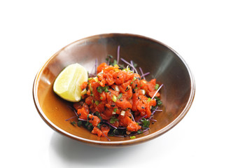 Salmon tartare. Tasty raw fish tartare with avocado and sesame seeds, served on sprouts.