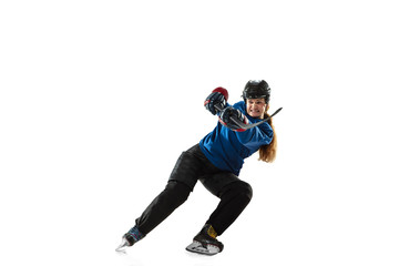 Fototapeta na wymiar Young female hockey player with the stick on ice court and white background. Sportswoman wearing equipment and helmet training. Concept of sport, healthy lifestyle, motion, action, human emotions.