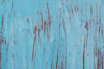 Obraz premium Wall covered with old paint for the backdrop. Vertical brush marks. Traces of rust. Primary colors - Polo Blue, Morning Glory, Van Cleef.